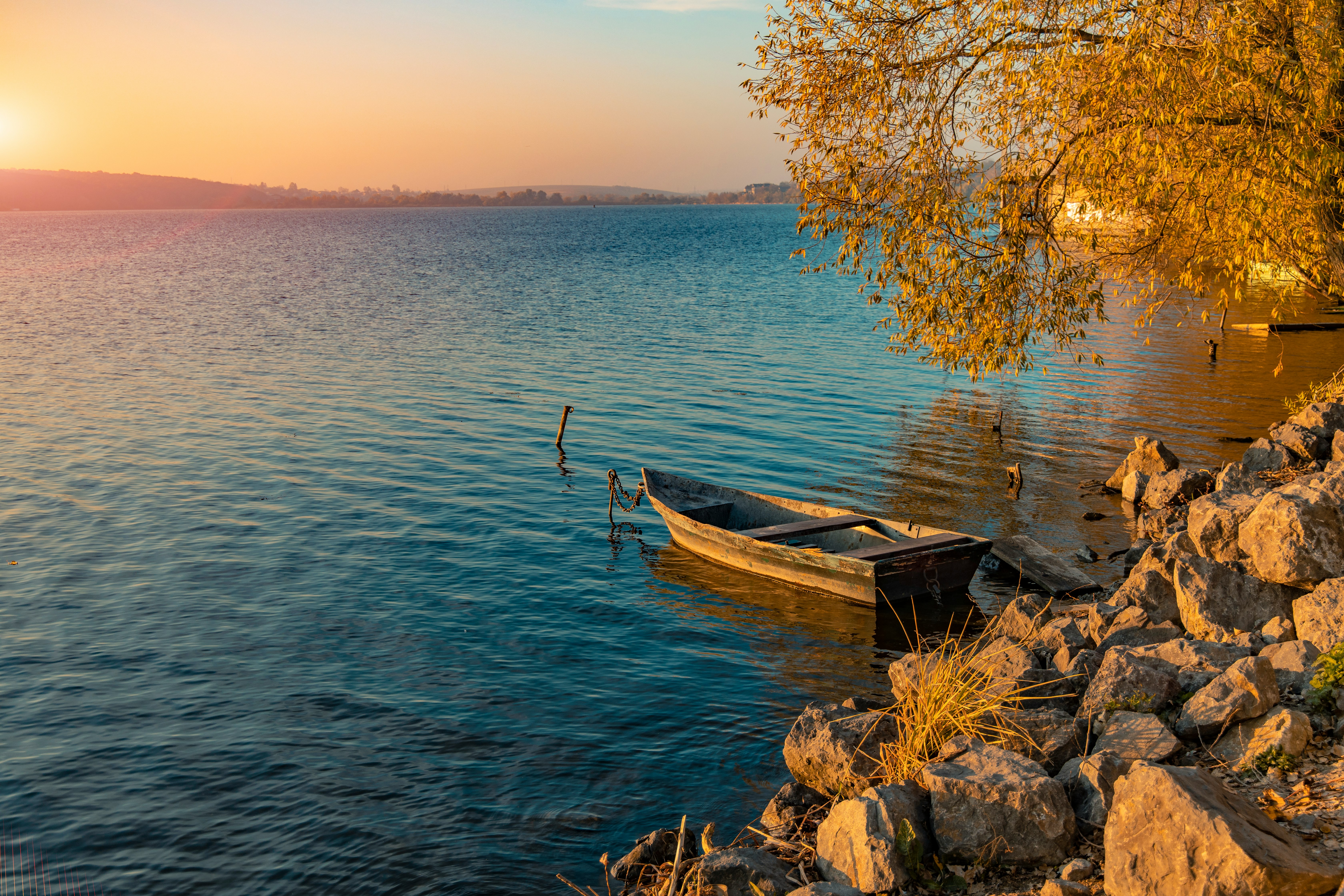 brown wooden boat on body of water during daytime